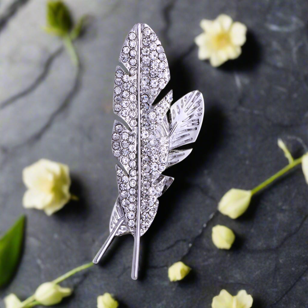 Close-up of a feather pin on a tailored navy suit, adding sophistication.