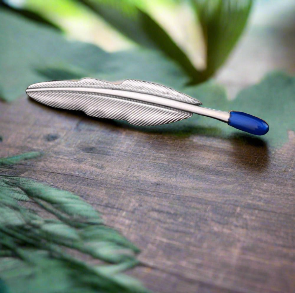 Close-up of a decorative mens tie bar with a gold finish and unique shape