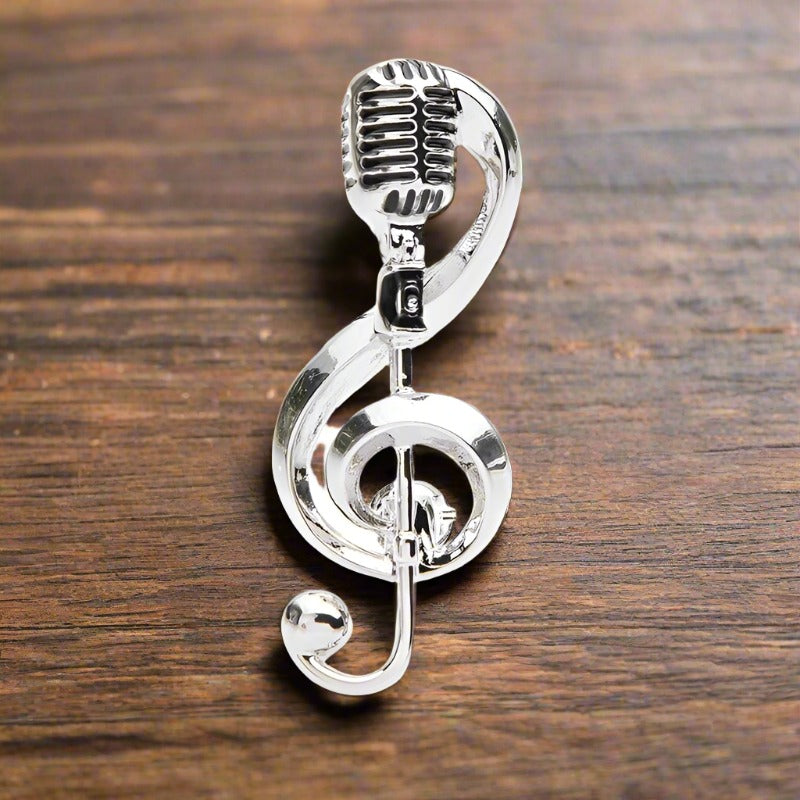 Elegant gold music lapel pin worn on a suit jacket for formal events