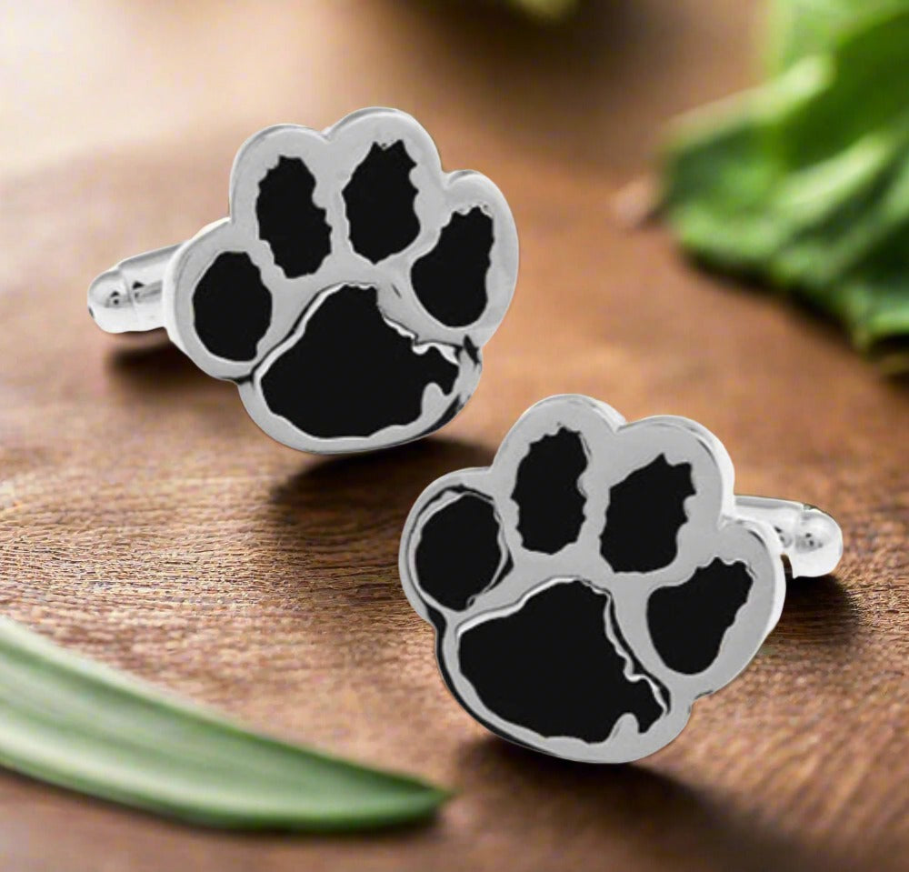 Close-up of paw print cufflinks in chrome finish on a men's shirt