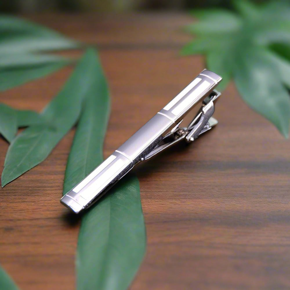 Gold checkerboard tie bar, adding a touch of modern elegance to mens dress accessories.