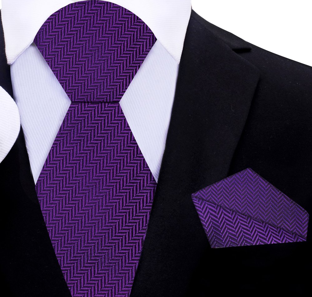 Elegant pink silk necktie displayed on a white dress shirt, showcasing the lined texture.