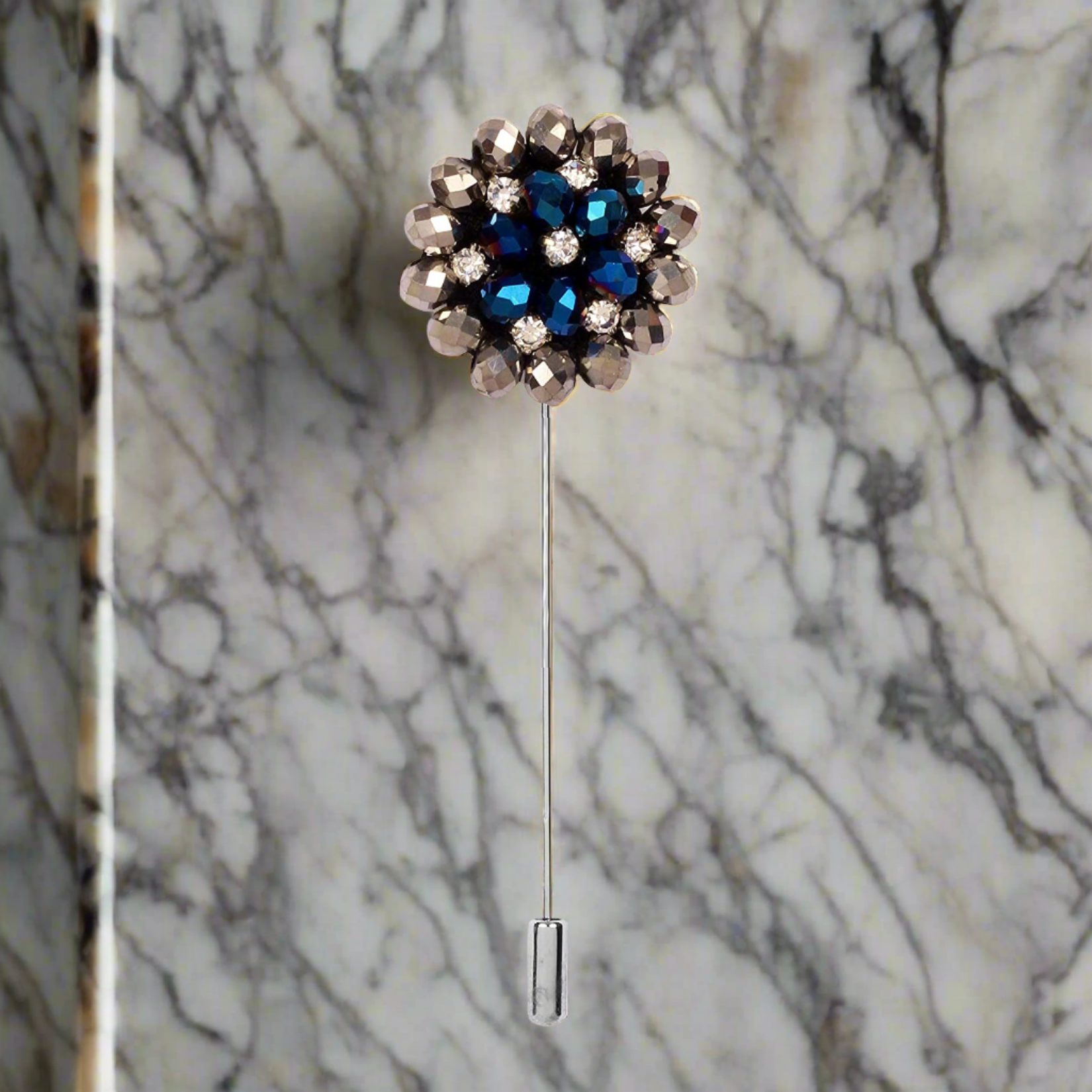 Close-up of a zinc alloy lapel pin with blue stones, suitable for suits