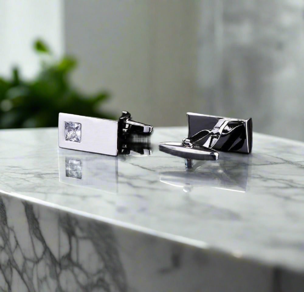 Chrome Elegance tie bar and cuff links set displayed elegantly on a suit jacket