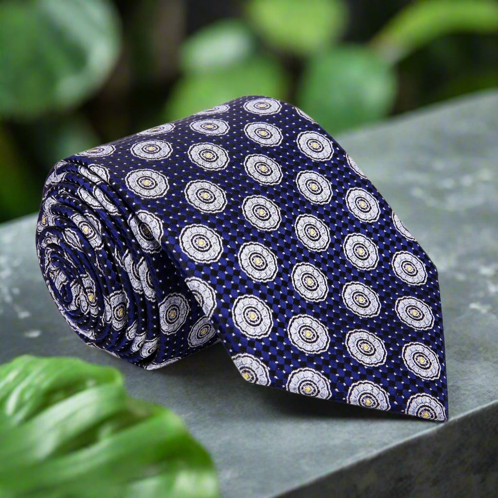 Close-up view of the blue and grey geometric silk tie, showcasing its intricate pattern.