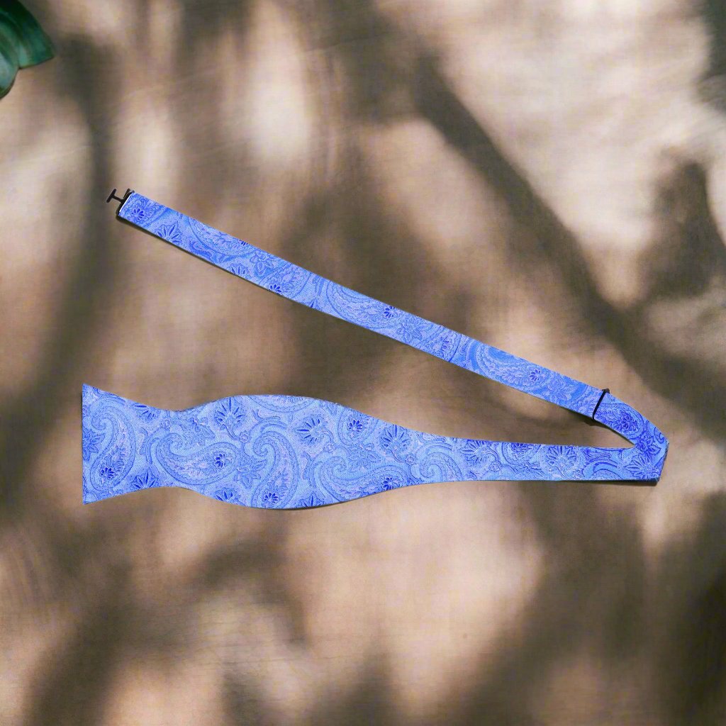 Front view of a blue paisley silk bow tie on a white background, perfect for weddings