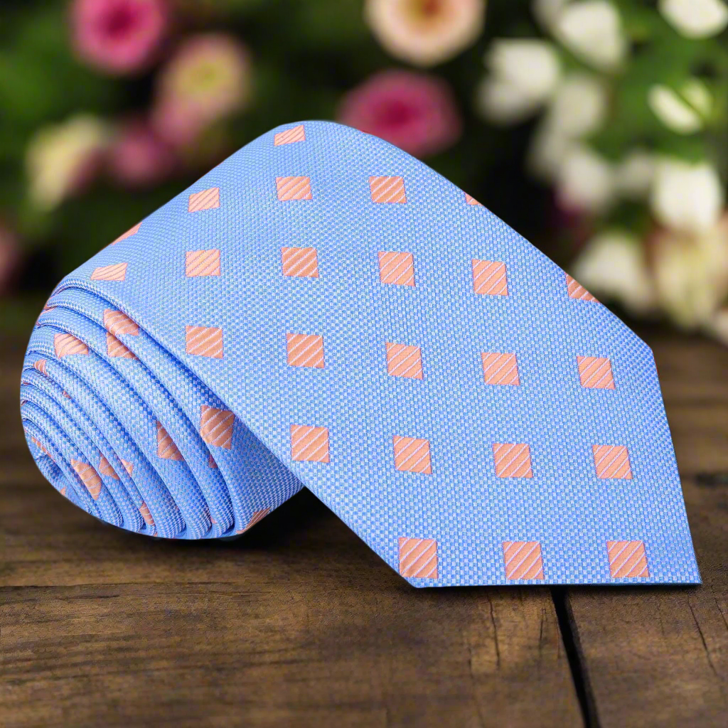 Light blue necktie with pink diamond pattern on a model's neck for formal events
