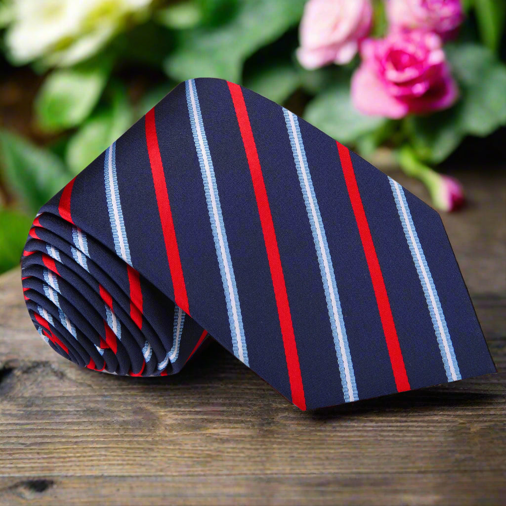 Close-up of a dark blue and red stripe silk tie, highlighting the fabric's sheen and pattern.