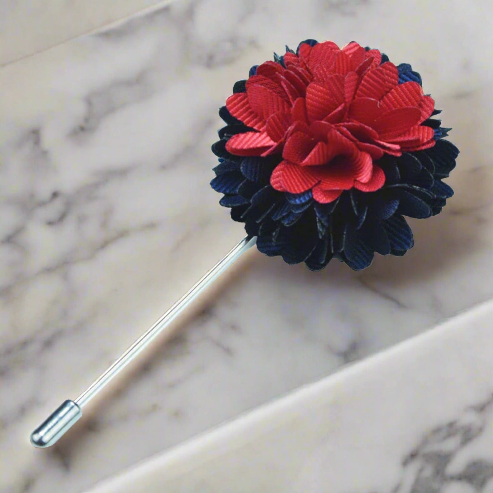 Close-up of vibrant red and blue flower lapel pin on a suit jacket for weddings