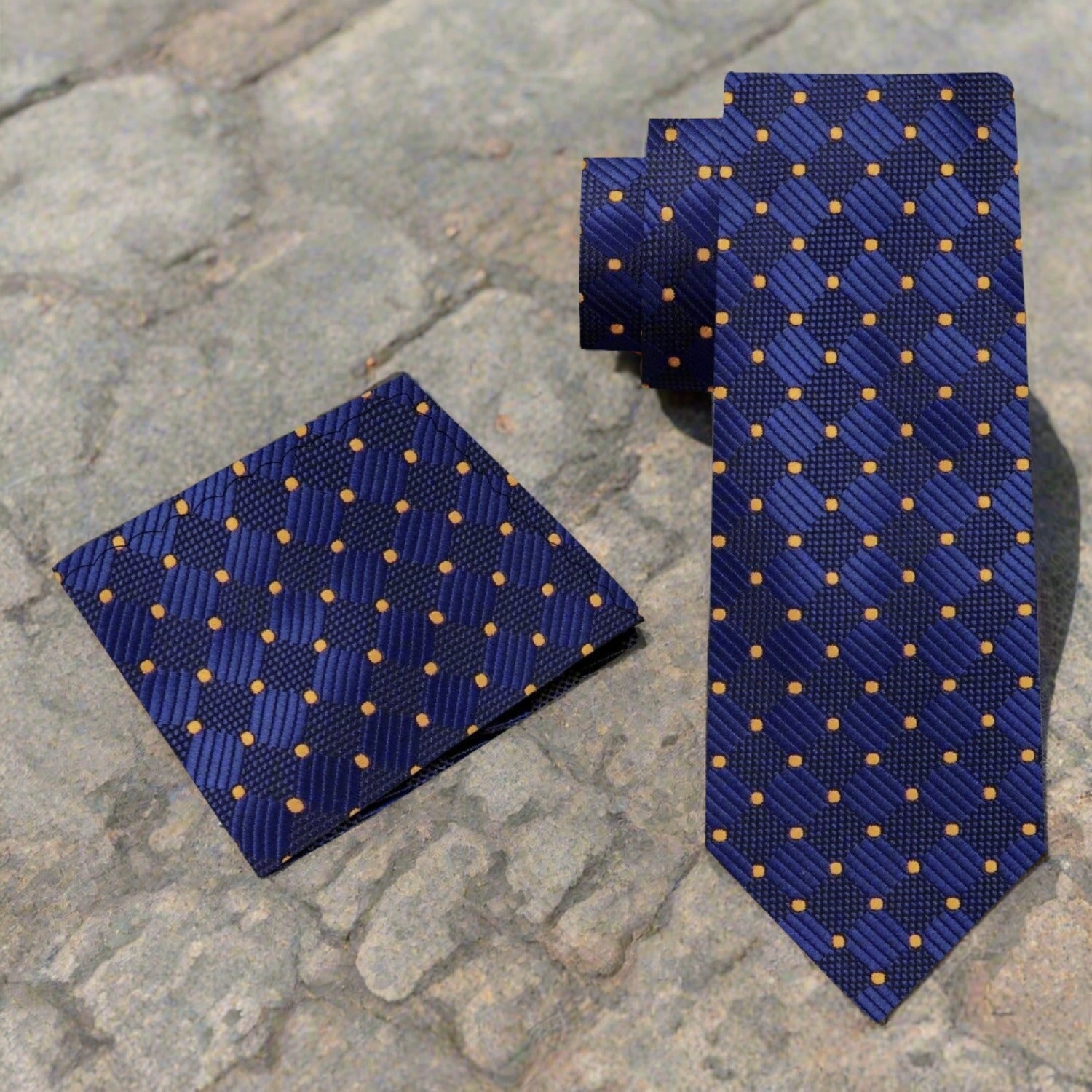 Silk necktie and pocket square set displayed on a stylish dress form