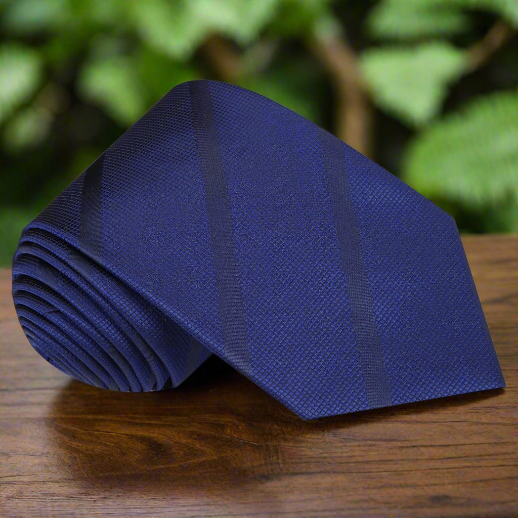 Deep navy blue stripe silk necktie hanging on a wooden hanger, ideal for weddings and formal events