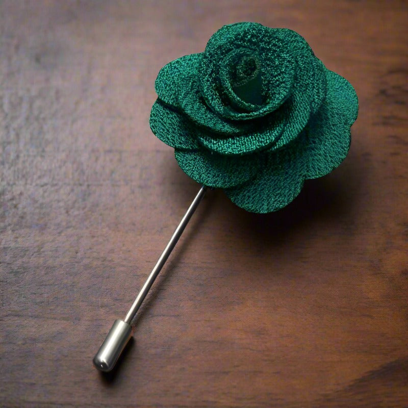 Close-up of a navy blue flower lapel pin highlighting the layered petals and polished alloy clasp