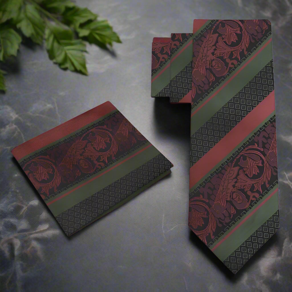 Close-up of the intricate paisley pattern on the brown and mint green silk necktie, showcasing its luxurious texture.