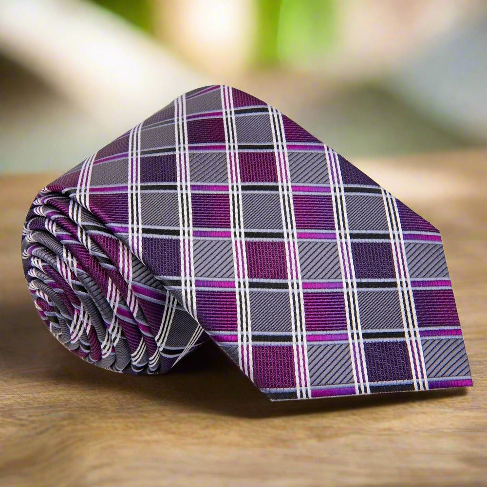 Elegant grey and purple silk tie with stripe pattern on a dress shirt