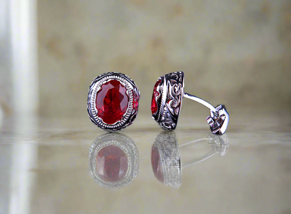 Close-up of Dracula cufflinks in red, blue, green, and black on a white shirt