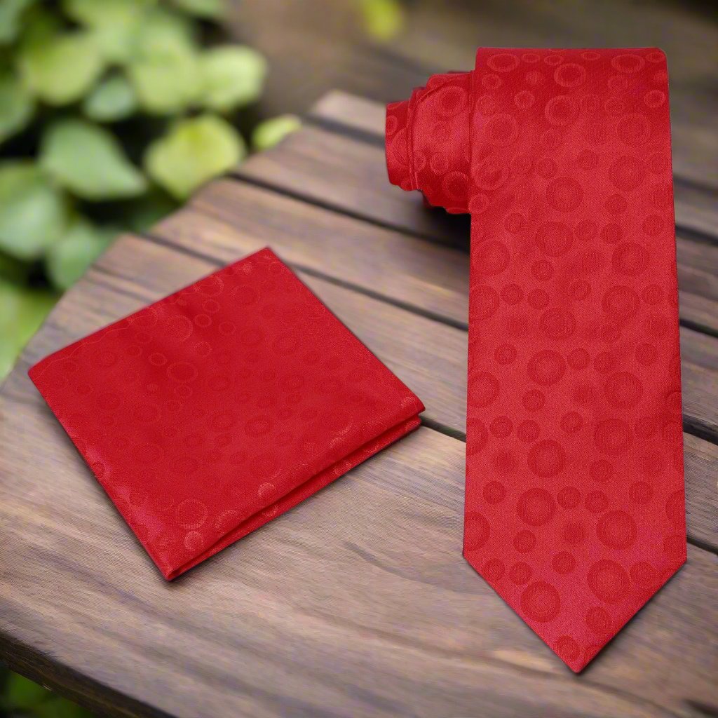 Close-up of the polka dot design on the green silk necktie, showcasing its texture.