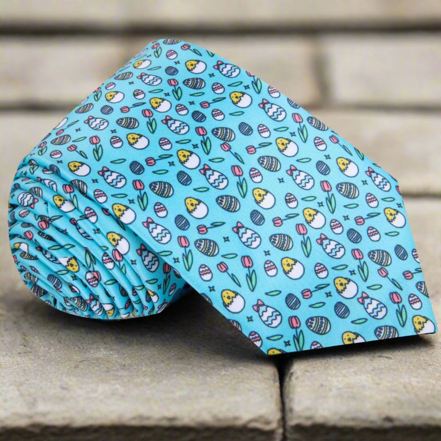 Close-up of Easter-themed silk necktie with chick and egg pattern for spring celebrations