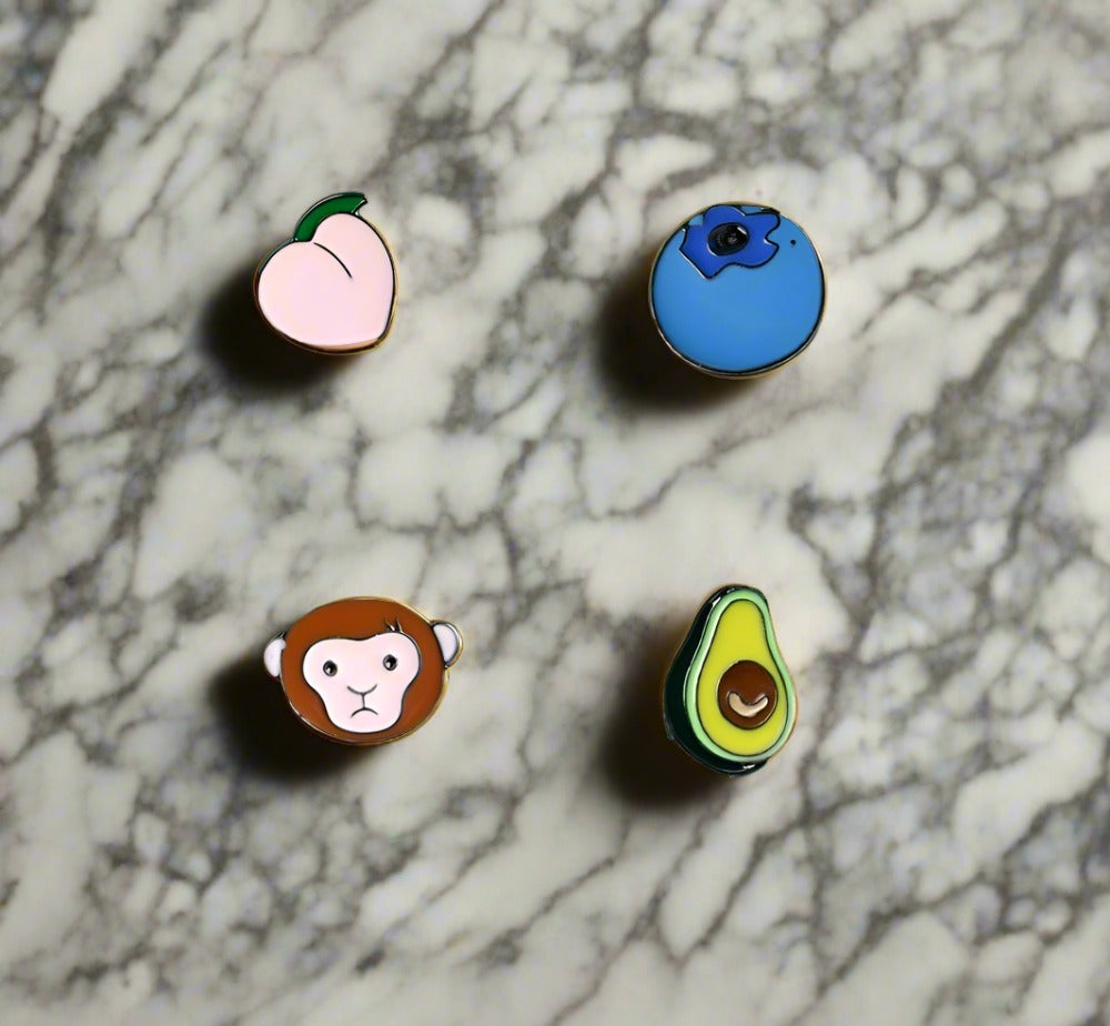 Close-up of a colorful cartoon monkey lapel pin, showing detailed zinc alloy craftsmanship
