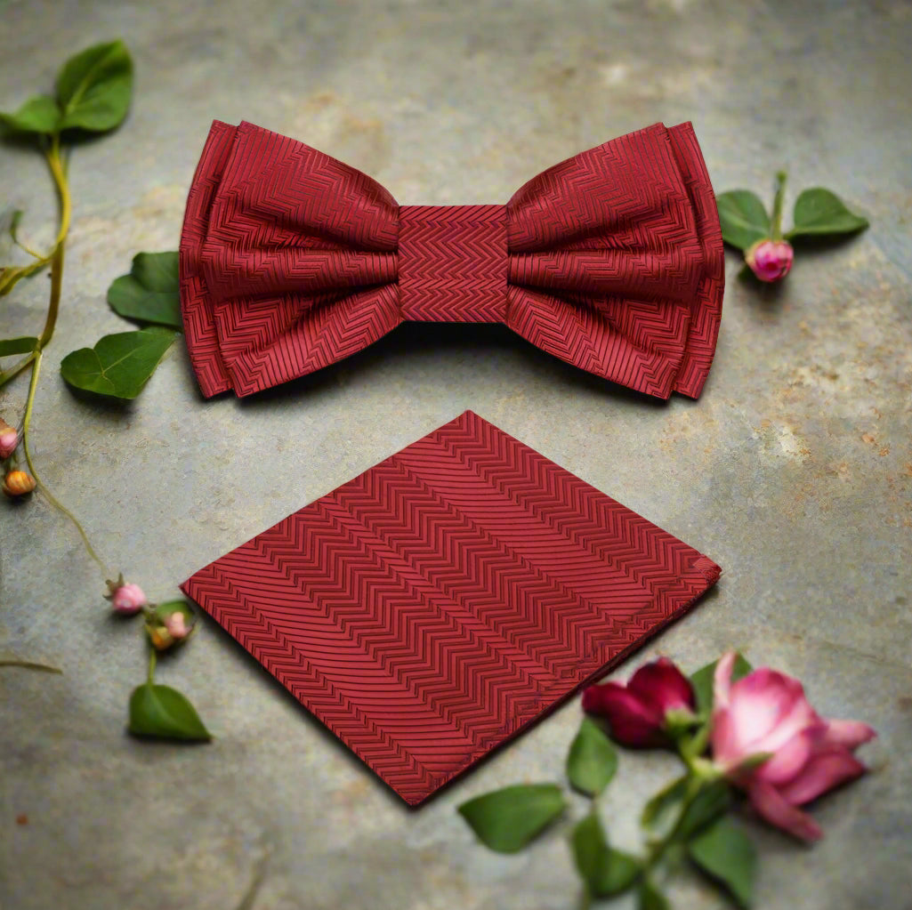 Close-up of the garnet red silk bow tie showing its luxurious fabric and solid lined texture.