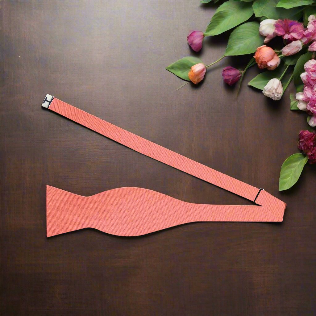 Pre-tied silk bow tie in rich coral, ideal for formal events.