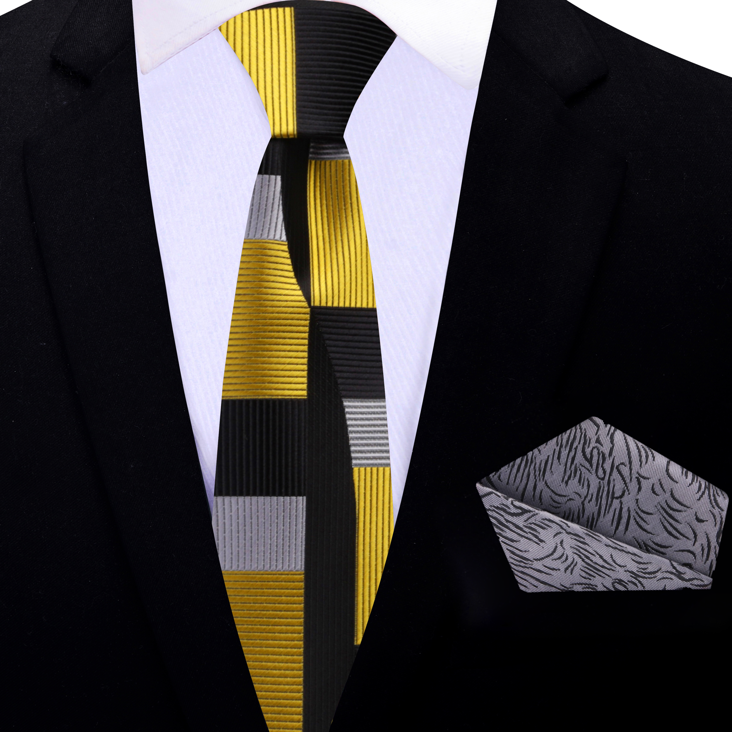 Elegant gold and black abstract silk tie draped over a wooden surface