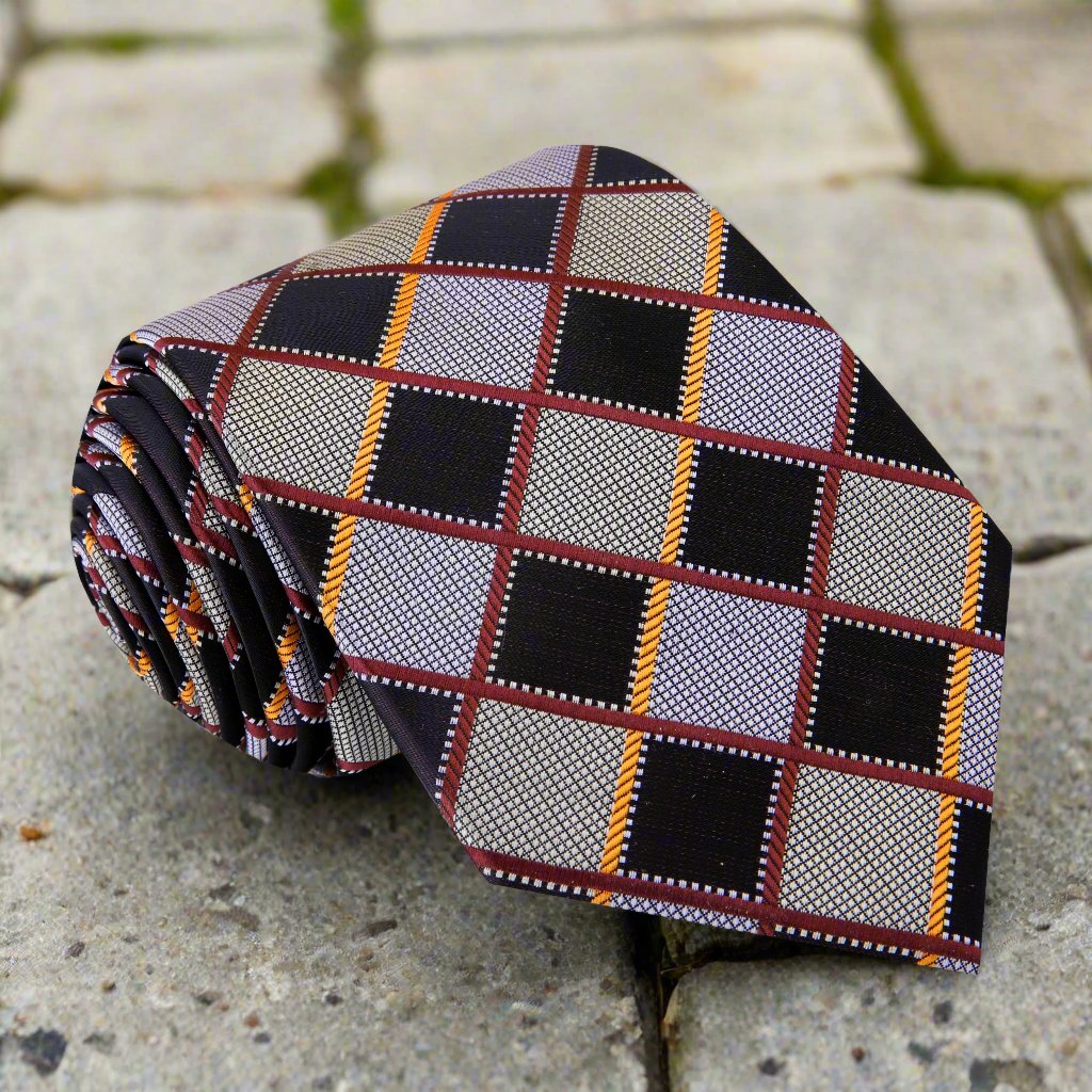 Elegant brown plaid silk necktie displayed on a tailored suit, showcasing its texture and pattern.
