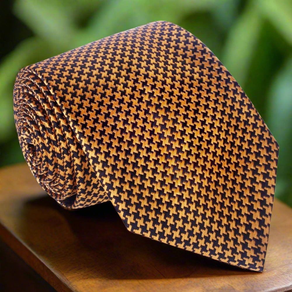 Close-up of metallic gold and black houndstooth silk necktie showcasing intricate pattern