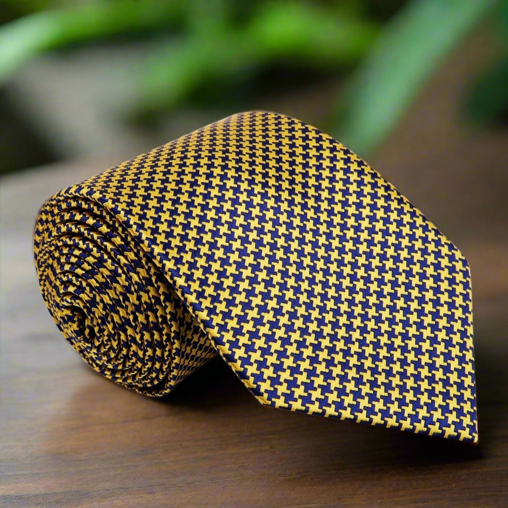 Close-up of metallic gold and black houndstooth silk necktie showcasing intricate pattern