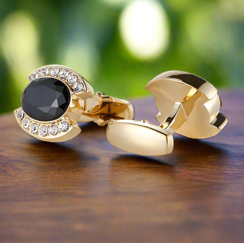 Gold cufflinks displayed alongside a navy blue suit, highlighting their luxurious appeal.
