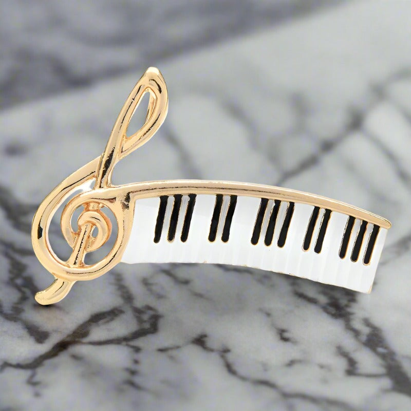 Gold music note lapel pin worn on a jacket, showcasing its elegant design.