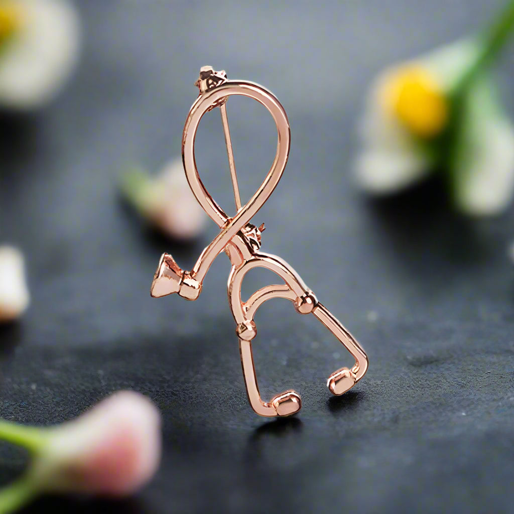 Stethoscope lapel pin displayed on a white dress shirt, highlighting its elegant design.