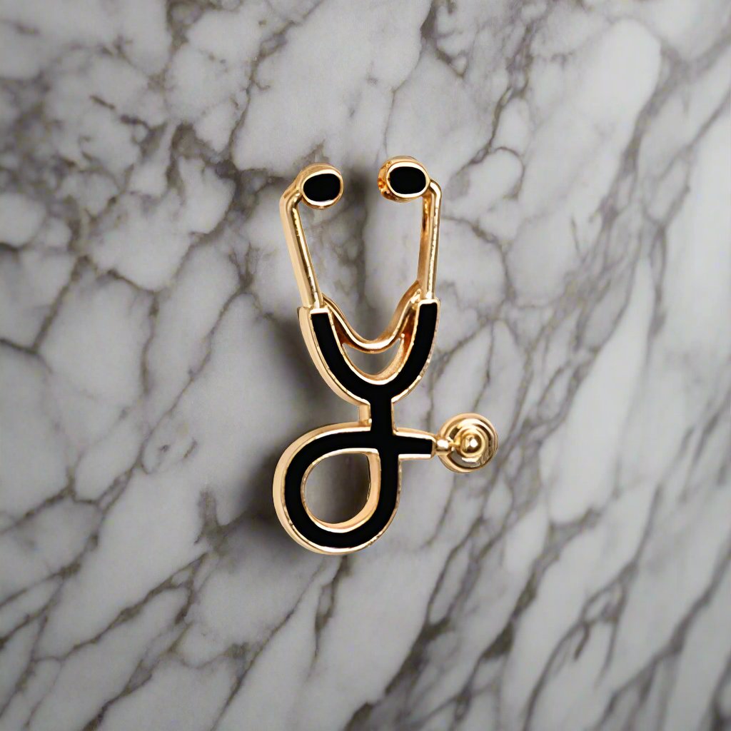 Stethoscope lapel pin displayed on a white dress shirt, highlighting its elegant design.