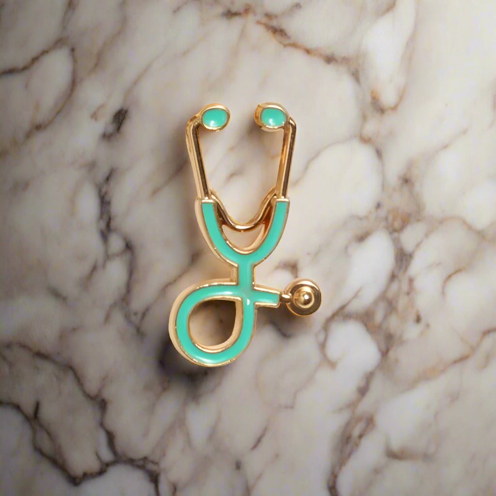 Stethoscope lapel pin displayed on a white dress shirt, highlighting its elegant design.