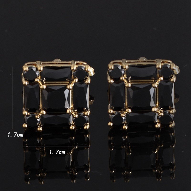 Stylish gold and clear gemstone cufflinks on a dress shirt