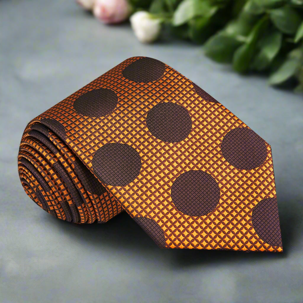 Close-up of golden orange polka dot silk tie on a dress shirt