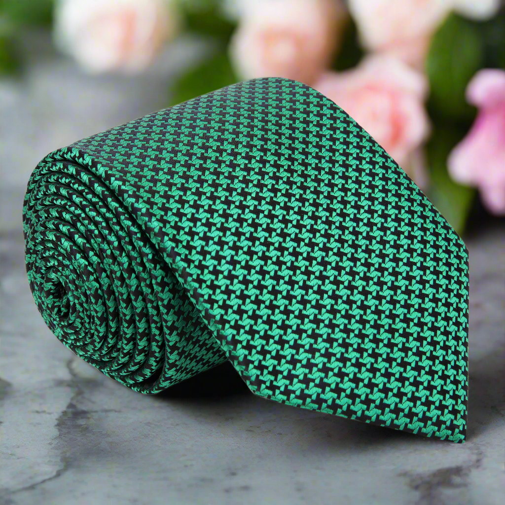 Front view of a men's green and black houndstooth silk necktie, perfect for formal occasions