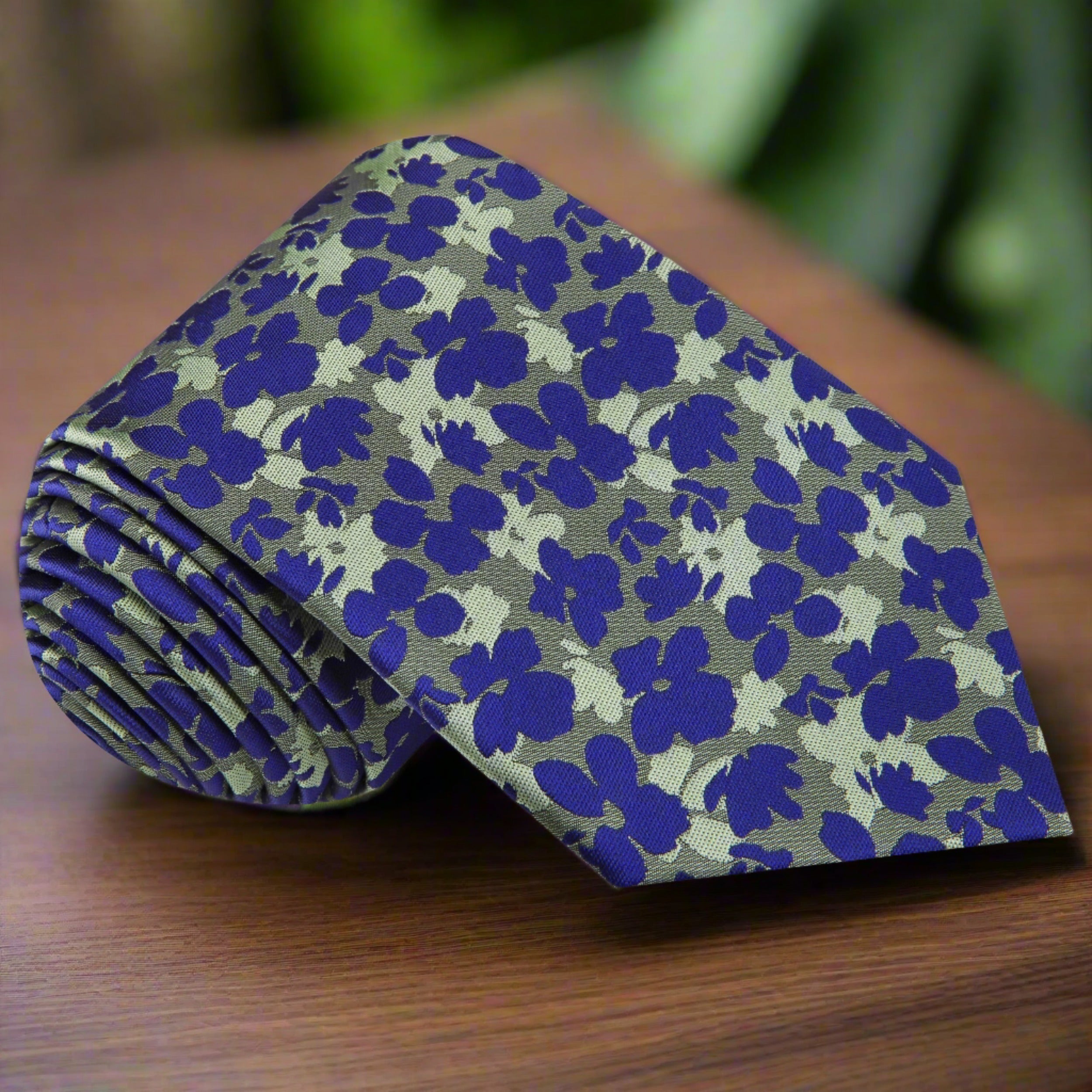 Front view of a stylish floral silk necktie in green and blue for summer occasions