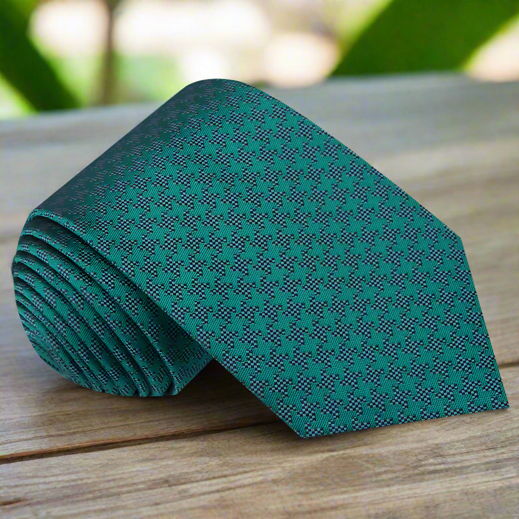 Close-up of navy blue silk tie with grey houndstooth pattern, suitable for formal events