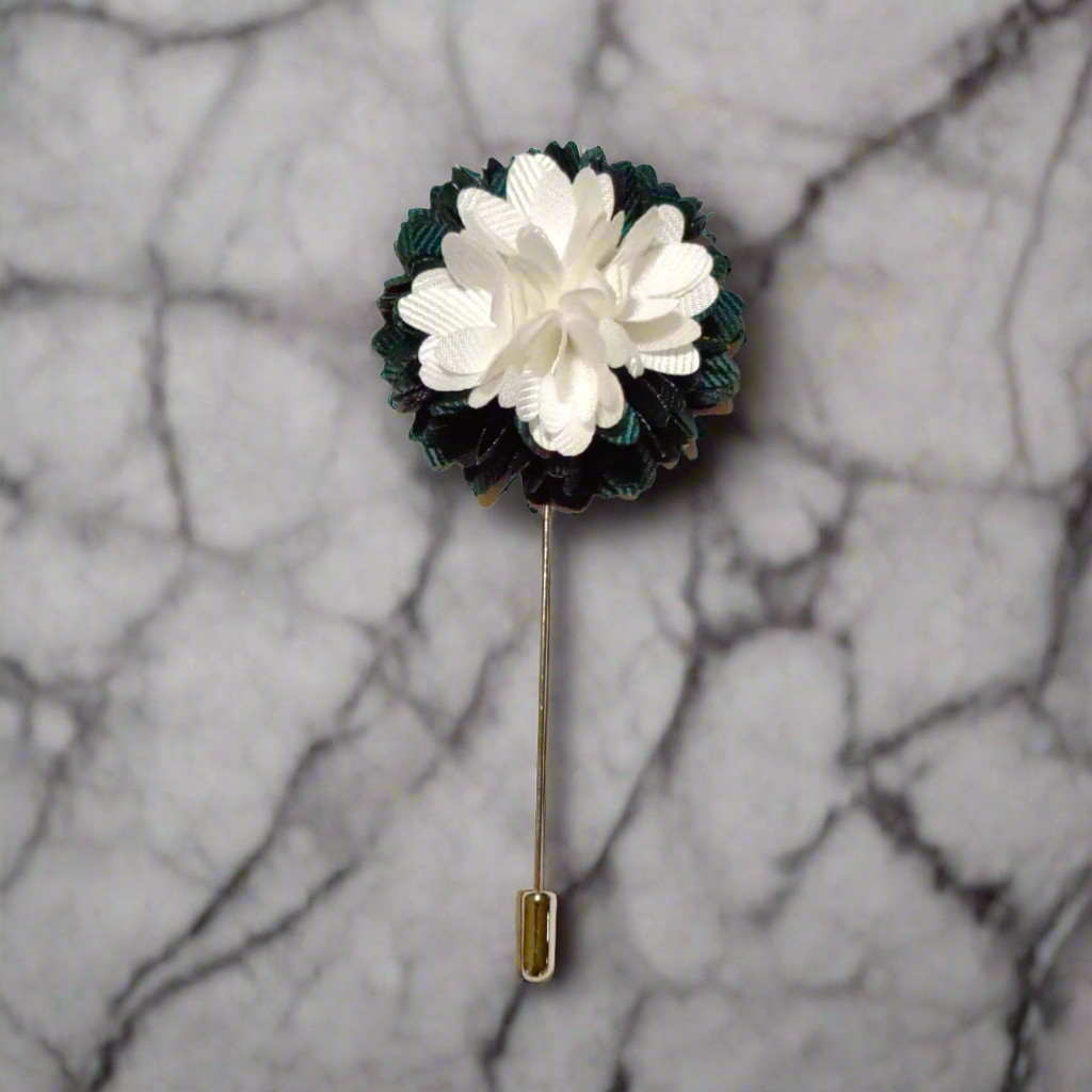 Elegant green and white flower lapel pin on a suit lapel