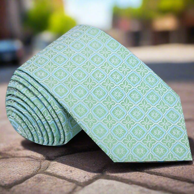Close-up of peach geometric silk tie showcasing its luxurious fabric and pattern.