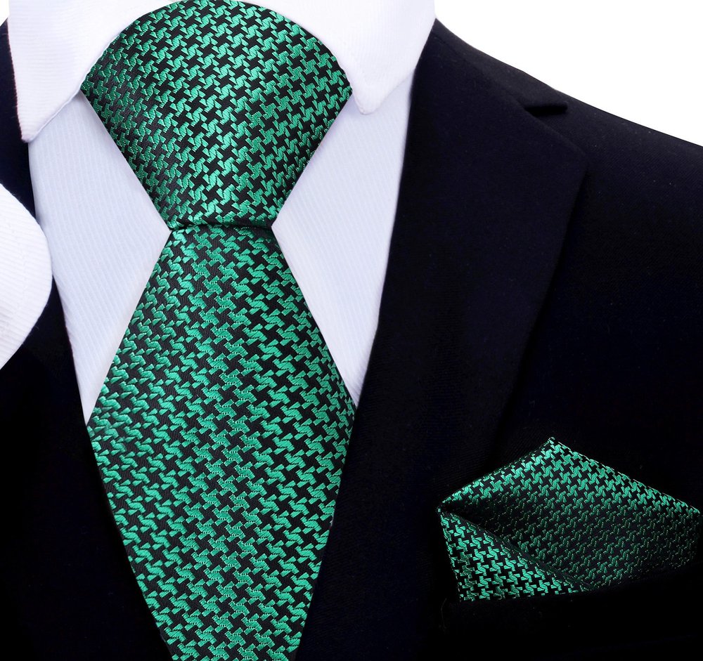 Matching pocket square in gold and black houndstooth design complementing the necktie