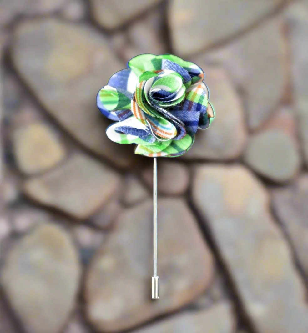 Elegant tartan lapel pin in green and blue on a suit collar