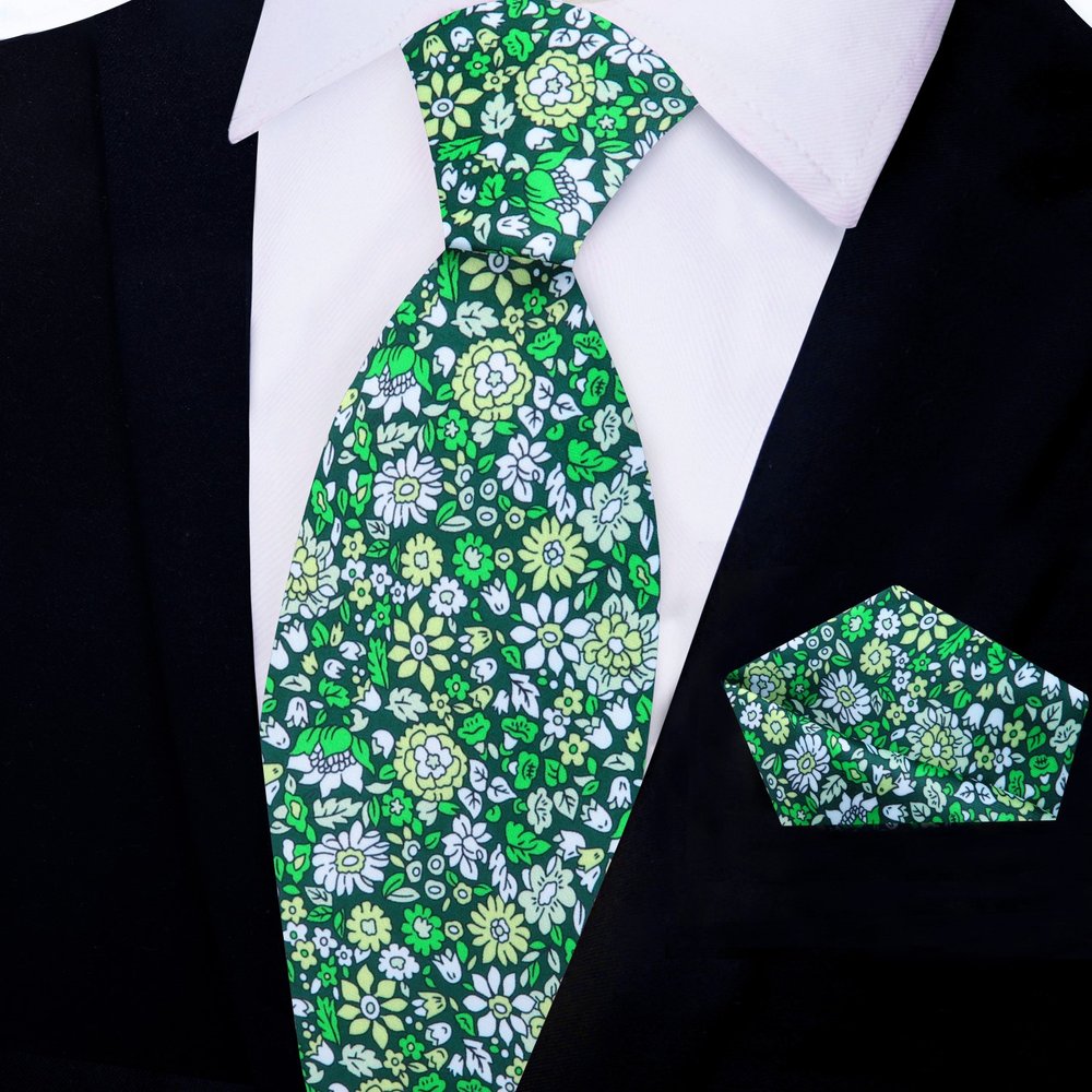 Elegant navy blue silk tie with floral pattern on a mannequin