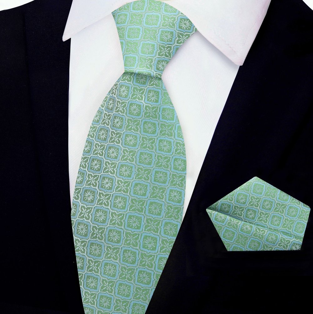 Silk necktie in peach pink with modern geometric design paired with formal suit