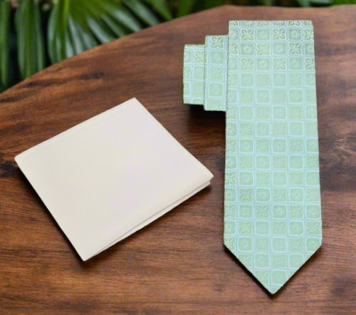 Close-up of geometric pattern silk necktie in peach pink on a display mannequin