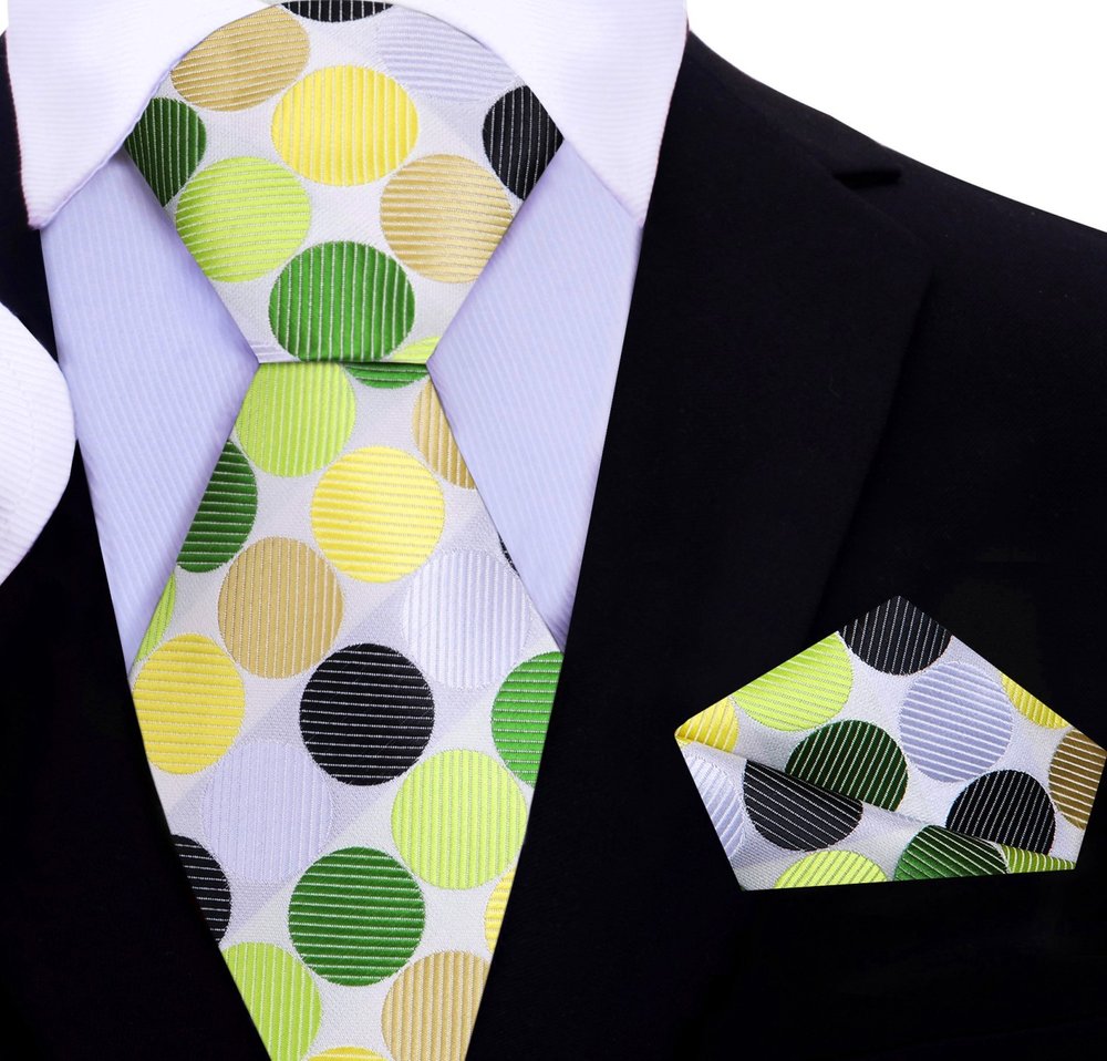 Large polka dot silk necktie in vibrant colors, showcasing the bold pattern against a white shirt.