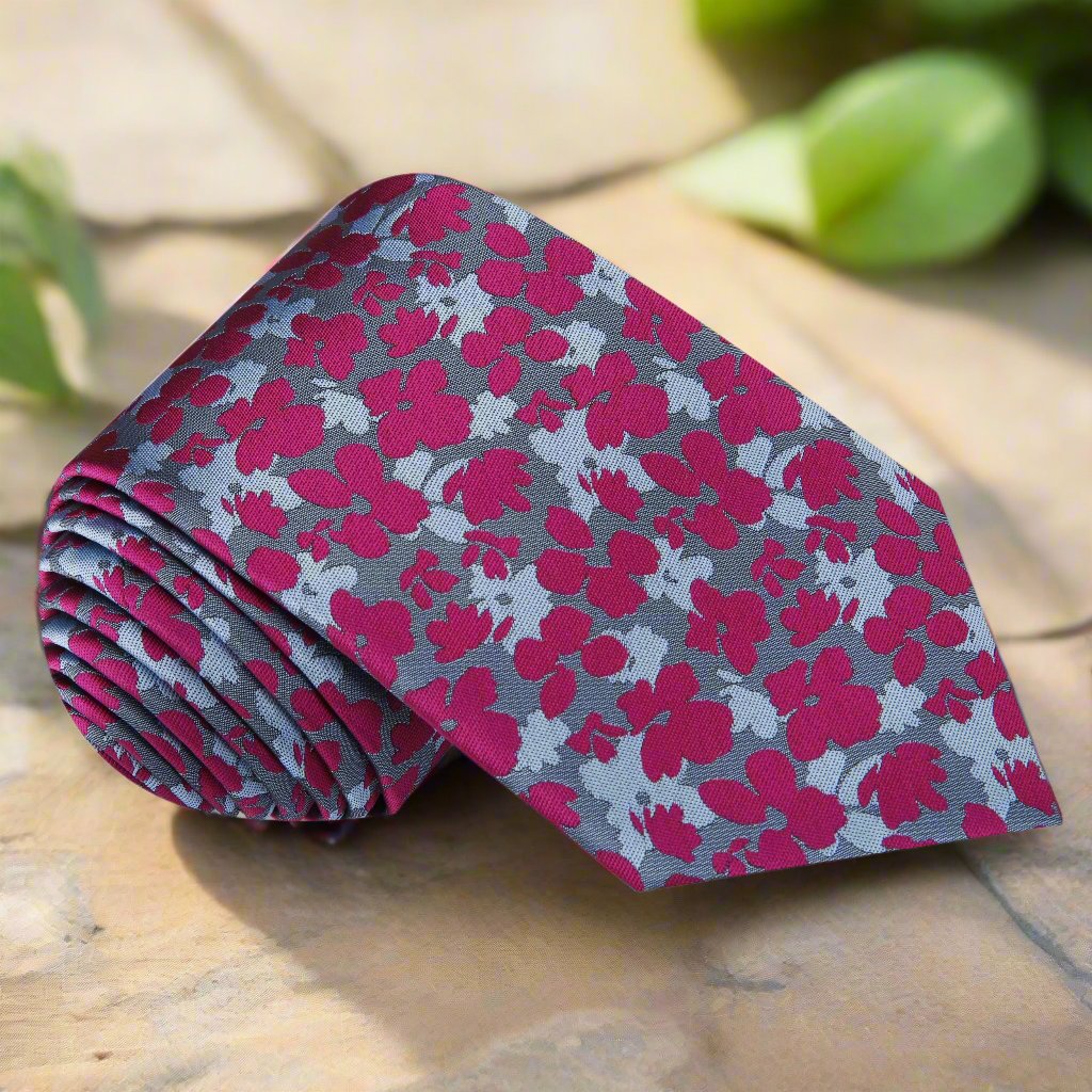 Close-up of the floral tie showing soft grey and blush tones