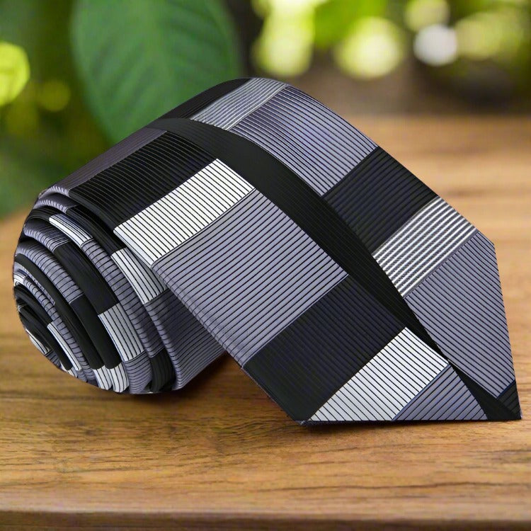 Close-up of Westcott mens geometric silk necktie with vibrant abstract pattern