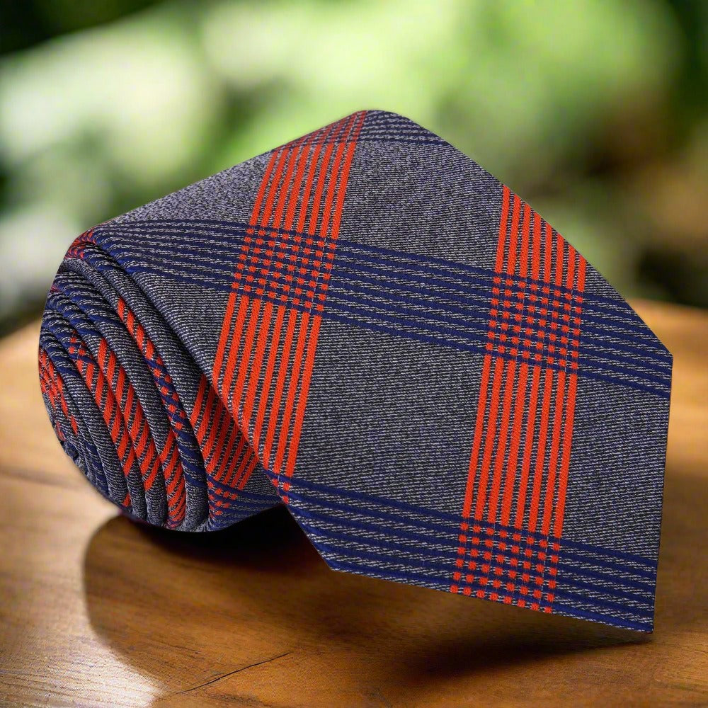 Front view of a men's silk plaid tie in grey, white, and black