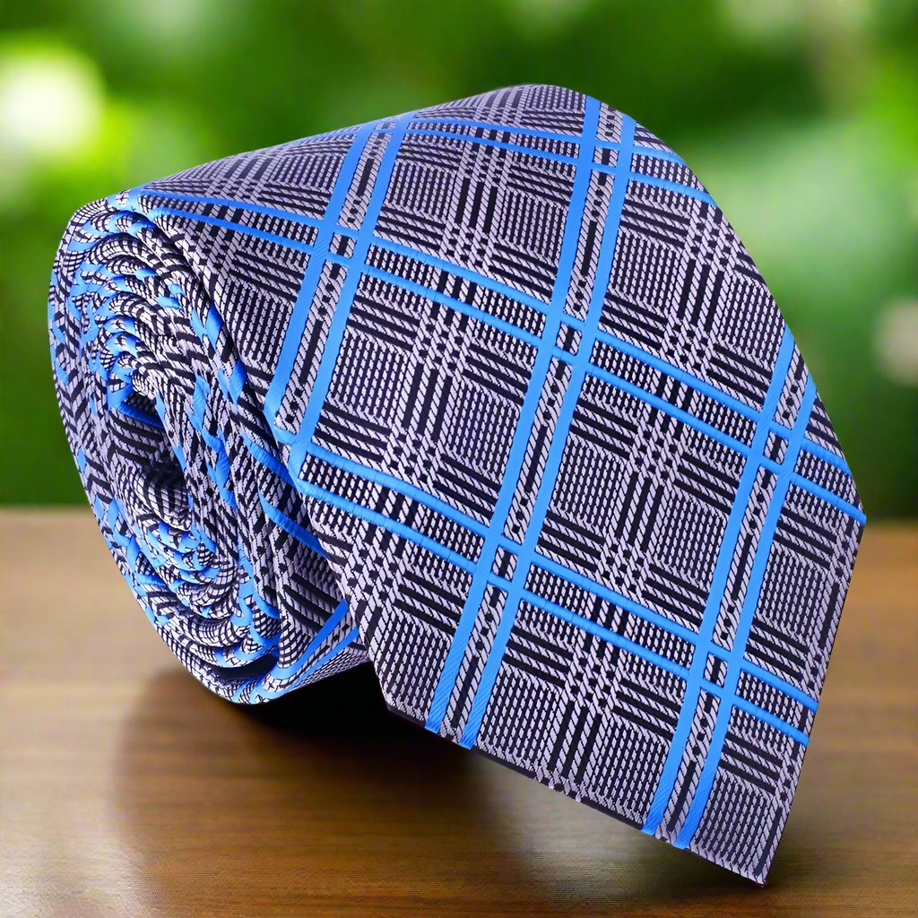 Close-up of the Warrenton plaid tie showcasing its vibrant purple and silver colors, perfect for formal occasions.